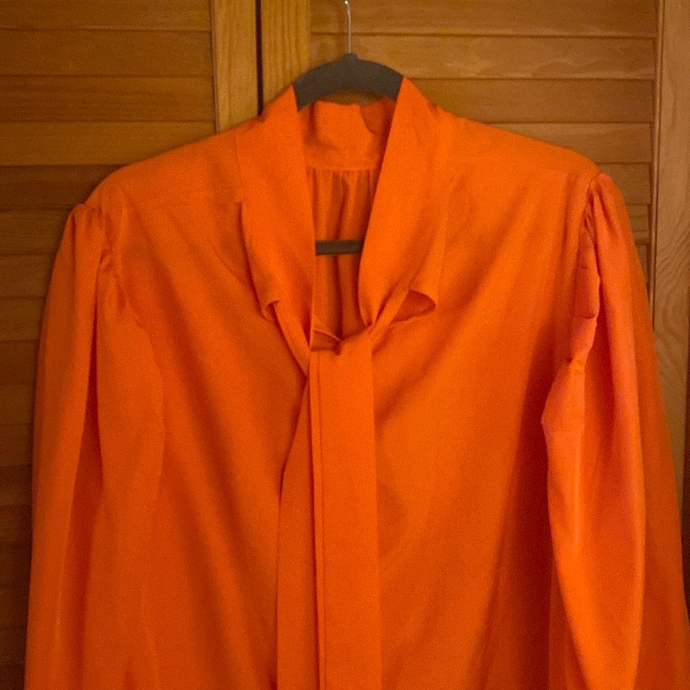 Plus Size. Cute orange front the ruffle sleeve top